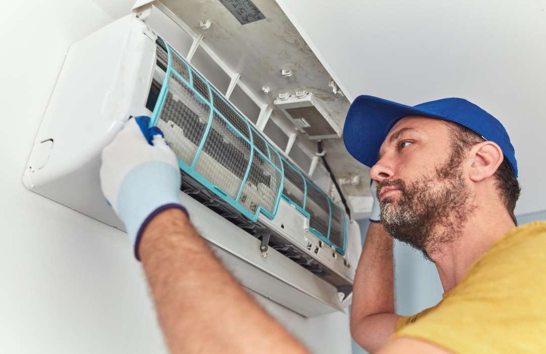 HVAC technician repairing AC