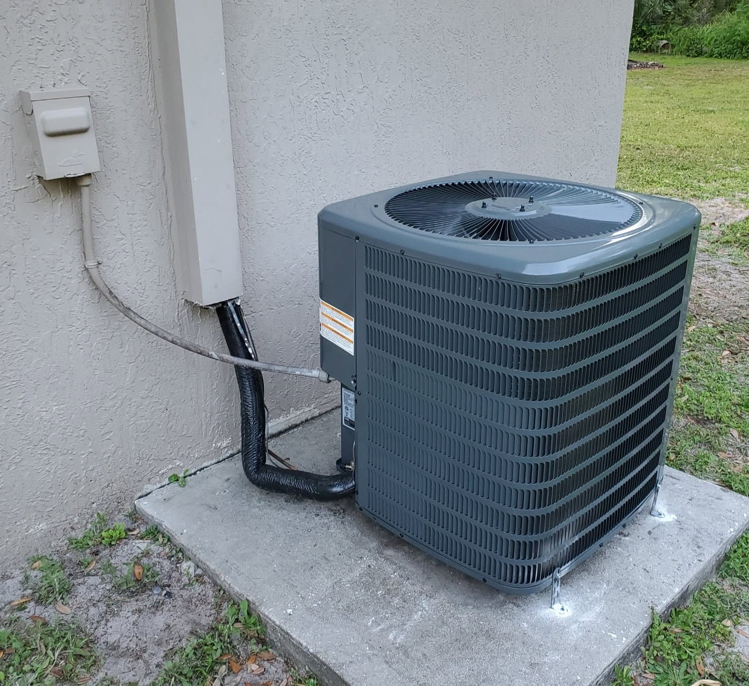 New outdoor AC condenser installed during an AC unit replacement project