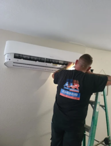 HVAC technician installing a new outdoor condenser during AC unit replacement